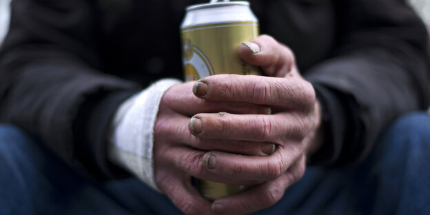 Schmutzige, aufgedunsene Hände halten eine Bierdose Schmutzige, aufgedunsene Hände halten eine Bierdose