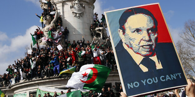 Demonstranten halten ein Plakat hoch, auf ihm ist das Porträt eines alten Mannes abgebildet. "No, you can't" steht darunter Demonstranten halten ein Plakat hoch, auf ihm ist das Porträt eines alten Mannes abgebildet. "No, you can't" steht darunter