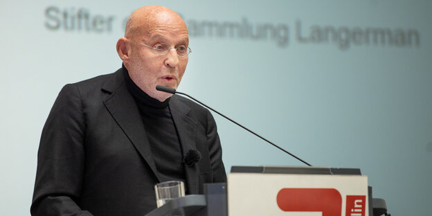 Ein Mann, Arthur Langerman, an einem Rednerpult Ein Mann, Arthur Langerman, an einem Rednerpult
