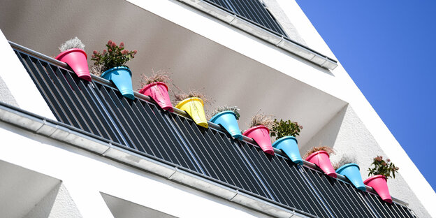 Ein Balkon mit bunten Blumentöpfen. Ein Balkon mit bunten Blumentöpfen.