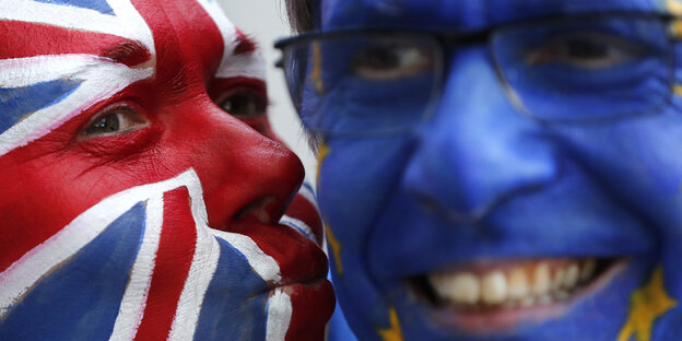 Ein mit UK-Flagge bemaltes Gedicht küsst ein mit EU-Flagge bemaltes Gesicht Ein mit UK-Flagge bemaltes Gedicht küsst ein mit EU-Flagge bemaltes Gesicht