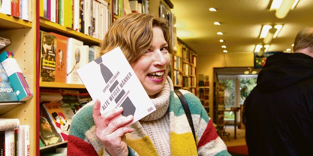 Jenneke de Vries hält ein Buch mit dem Titel "Alte weiße Männer" in der Hand. Jenneke de Vries hält ein Buch mit dem Titel "Alte weiße Männer" in der Hand.