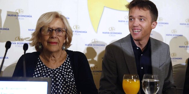 Manuela Carmena und Iñigo Errejón sitzen vor Mikrofonen Manuela Carmena und Iñigo Errejón sitzen vor Mikrofonen