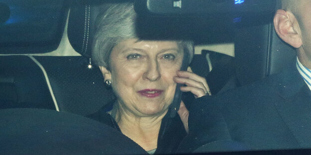 Eine Frau sitzt im Auto und telefoniert. Es ist Theresa May Eine Frau sitzt im Auto und telefoniert. Es ist Theresa May