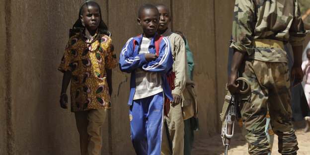 Soldat neben Kindern in Niger Soldat neben Kindern in Niger