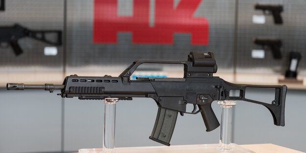 Das Sturmgewehr G36 vor dem Heckler und Koch Logo Das Sturmgewehr G36 vor dem Heckler und Koch Logo