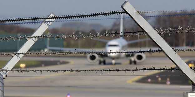 Ein Flugzeug hinter Stacheldraht