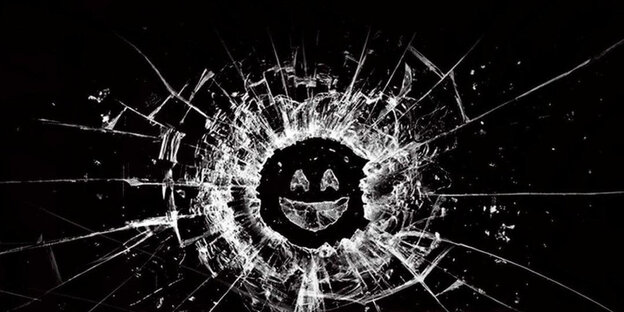 Das Logo der Serie "Black mirror" ein Loch in der Scheibe, aus der ein Smiley diabolisch lächelt