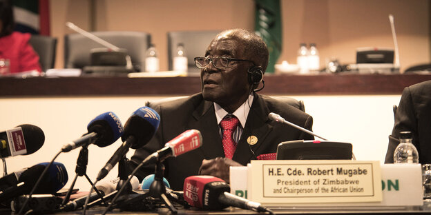 Simbabwes Präsident Mugabe sitzt hinter Mikrofonen auf dem AU-Gipfel Simbabwes Präsident Mugabe sitzt hinter Mikrofonen auf dem AU-Gipfel