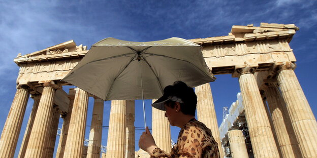 Tourist mit Schirm vor der Akropolis Tourist mit Schirm vor der Akropolis