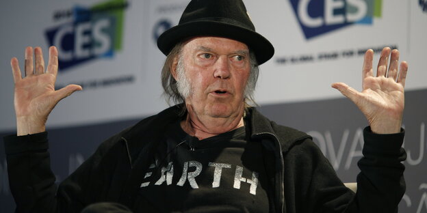 Neil Young mit erhobenen Händen Neil Young mit erhobenen Händen