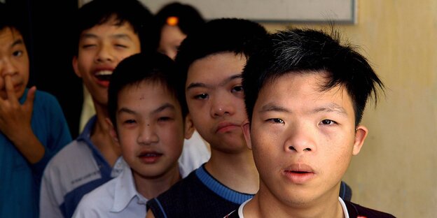 Fünf vietnamesische Jungs schauen direkt in die Kamera. Fünf vietnamesische Jungs schauen direkt in die Kamera.
