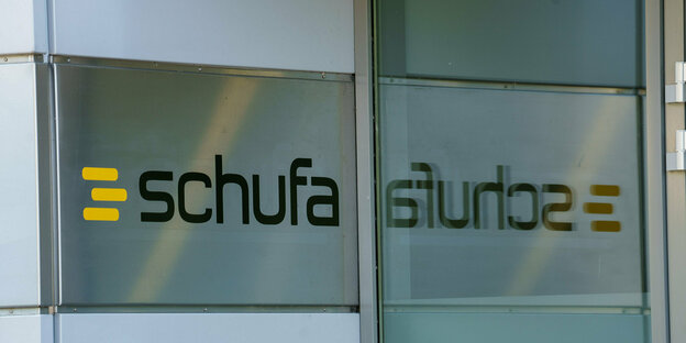 The Schufa logo is attached to a wall of the company headquarters in Wiesbaden