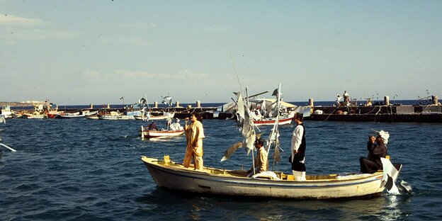 A woman sings on a boat in which there are three men