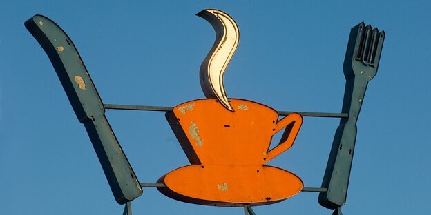 Neon sign with a motif of a coffee cup and a knife and fork