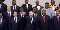 Putin winkt in einem Gruppenbild mit afrikanischen Staatsführern.