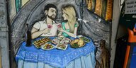 Grafitto, zeigt ein junges Paar beim Essen, typische georgische Speisen in Tiflis
