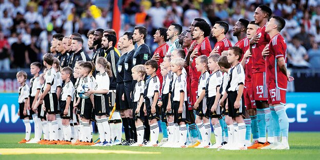 German national football team men with children in the stadium