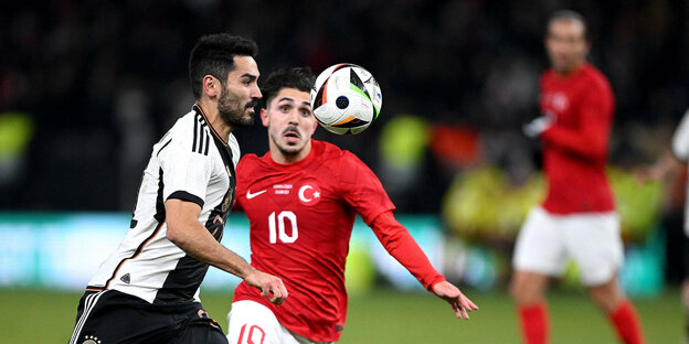 Footballer Ilkay Guendogan with opponent and ball.