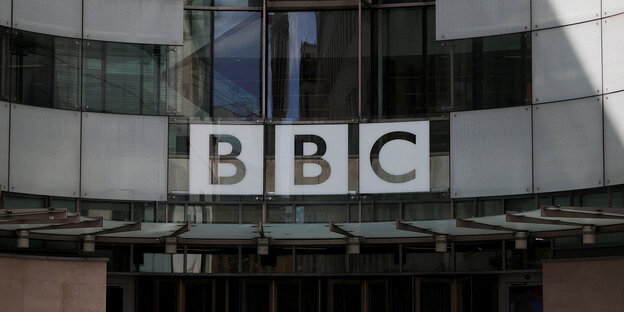 The BBC logo on a glass wall.