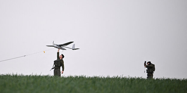 Israeli soldiers launch a drone
