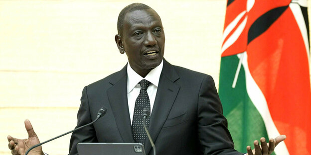 William Ruto pointing at a lectern