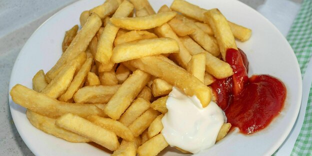 French fries with ketchup and mayonnaise served on a plate