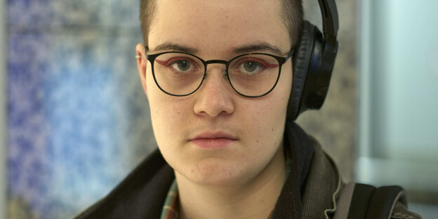 Portrait photo of a young person with glasses.