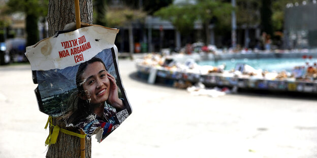 A poster with the portrait of a woman kidnapped by Hamas hangs in Tel Aviv's Dizengoff Square.