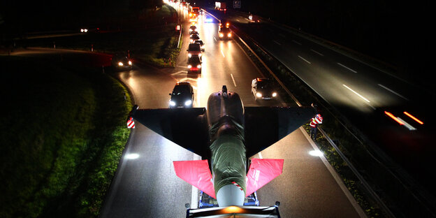 Ein Kampfflugzeug wird nachts auf einer Autobahn transportiert. Ein Kampfflugzeug wird nachts auf einer Autobahn transportiert.