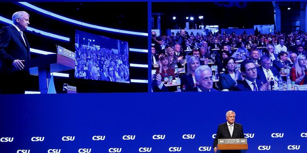 Horst Seehofer spricht vor einer blauen Wand mit großen Monitoren.