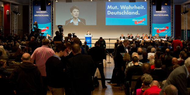 Menschen schauen auf ein Podium, auf dem Frauke Petry steht Menschen schauen auf ein Podium, auf dem Frauke Petry steht