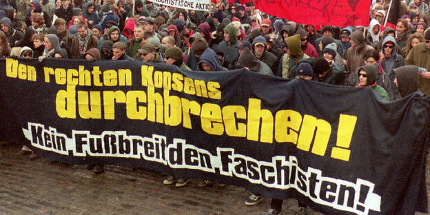 Demonstrant_innen halten ein Transparent „Den rechten Konsens durchbreche! Kein Fußbreit den Faschisten!“ hoch Demonstrant_innen halten ein Transparent „Den rechten Konsens durchbreche! Kein Fußbreit den Faschisten!“ hoch