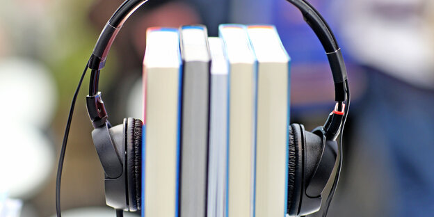 Kopfhörer klemmt auf Büchern Kopfhörer klemmt auf Büchern