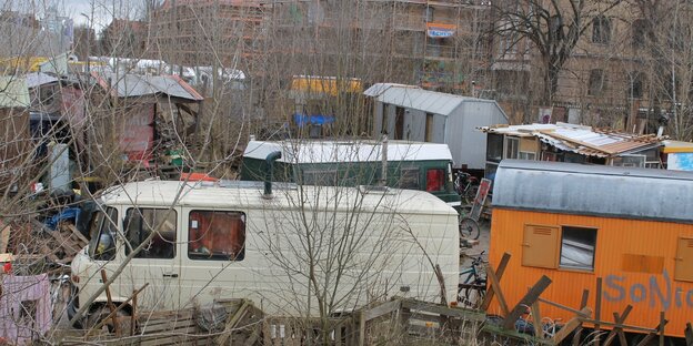 Bauwagen stehen neben kahlen Bäumen Bauwagen stehen neben kahlen Bäumen