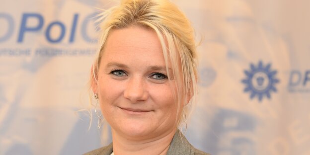 Eine Frau vor einer Polizei-Werbewand Eine Frau vor einer Polizei-Werbewand