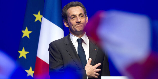 Nicolas Sarkozy steht vor der französischen Flagge Nicolas Sarkozy steht vor der französischen Flagge