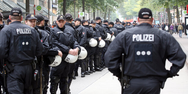 Viele Polizisten stehen mit Demonstrationsausrüstung auf einer Straße in Hamburg Viele Polizisten stehen mit Demonstrationsausrüstung auf einer Straße in Hamburg