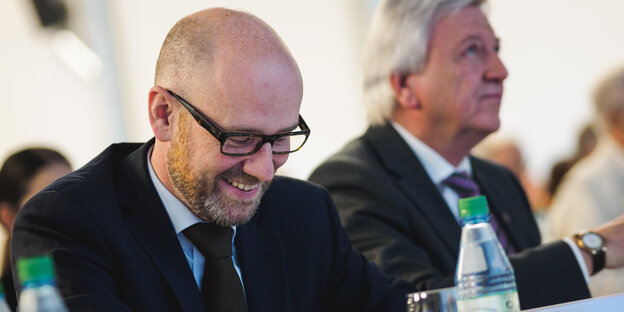 Volker Tauber grinst und guckt nach unten Volker Tauber grinst und guckt nach unten