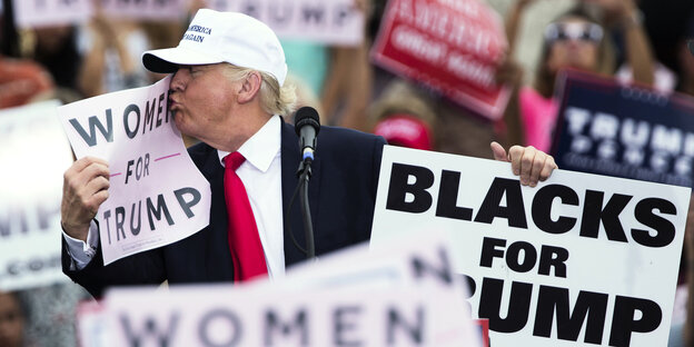 Trump küsst ein "Women for Trump"-Plakat Trump küsst ein "Women for Trump"-Plakat