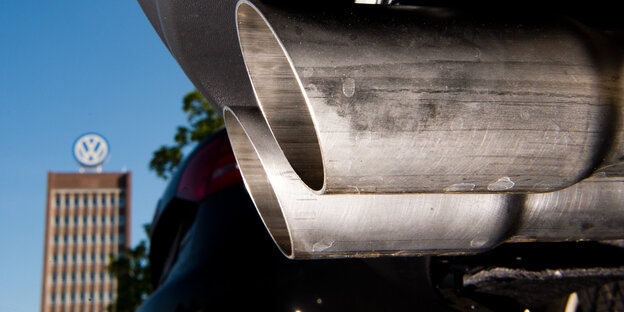 Der Auspuff eines Autos. Im Hintergrund VW-Zentrale. Der Auspuff eines Autos. Im Hintergrund VW-Zentrale.