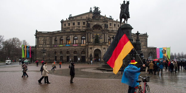 Demonstrant mit Deutschlandfahne vor der Semperoper in Dresden Demonstrant mit Deutschlandfahne vor der Semperoper in Dresden