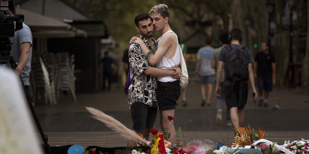 Zwei Männer umarmen sich und trauen nach dem Terroranschlaf im Barcelona Zwei Männer umarmen sich und trauen nach dem Terroranschlaf im Barcelona