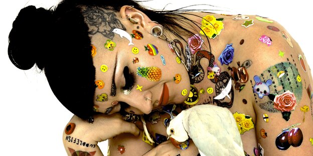 Unbekleidete Frau mit Tattoos, Sticker und Vogel Unbekleidete Frau mit Tattoos, Sticker und Vogel