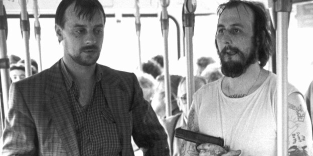 Dieter Degowski und Hans-Jürgen Rösner stehen in einem Bus, Rösner hält eine Waffe Dieter Degowski und Hans-Jürgen Rösner stehen in einem Bus, Rösner hält eine Waffe