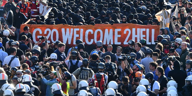 Vermummte hinter Banner "Welcome to hell" auf der gleichnamigen Demonstration Vermummte hinter Banner "Welcome to hell" auf der gleichnamigen Demonstration