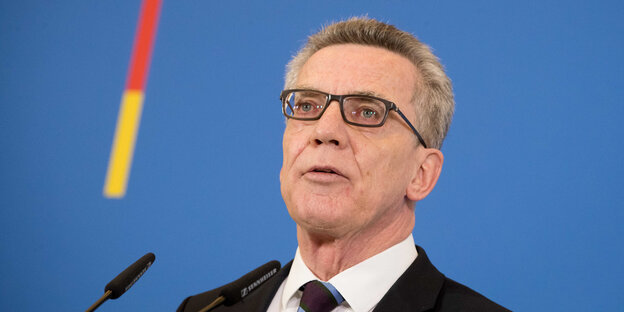 Thomas de Maizière vor blauem Hintergrund Thomas de Maizière vor blauem Hintergrund