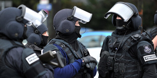 Drei Polizisten mit Helmen Drei Polizisten mit Helmen