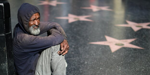 Ein dunkelhäutiger Obdachlose am Hall of Fame in Los ANgeles