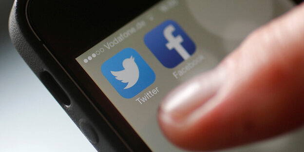Ein Finger zeigt auf Smartphone-Apps Ein Finger zeigt auf Smartphone-Apps